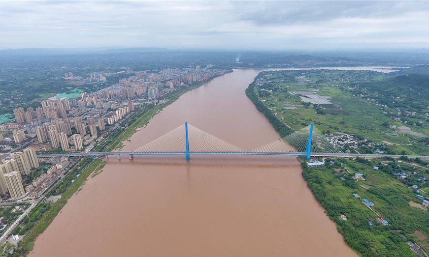 四川省宜賓市南溪區(qū)境內(nèi)的南溪仙源長江大橋于2015年開工建設(shè)，2019年1月30日大橋建成通車。南溪仙源長江大橋順利建成通車，結(jié)束了當(dāng)?shù)厝罕娨揽繑[渡過江的歷史，方便了兩岸居民來往出行，促進(jìn)了當(dāng)?shù)亟?jīng)濟(jì)社會(huì)發(fā)展。圖為7月23日，無人機(jī)拍攝的南溪仙源長江大橋與宜賓市南溪區(qū)城區(qū)（左）。（新華社記者 劉坤 攝）