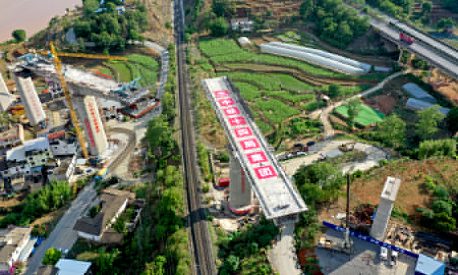 中國鐵建所屬中鐵十四局建設(shè)者介紹，他們需要先預(yù)制好高40米、長86米的“T”字形的墩身橋梁結(jié)構(gòu)，然后借助橋墩下部的球鉸裝置，在一個半小時的鐵路“天窗”作業(yè)時間內(nèi)，緩緩轉(zhuǎn)動橋梁，使之與相鄰的橋面吻合。圖為大橋轉(zhuǎn)體中。
