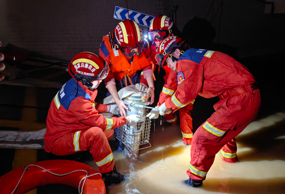 6月21日，接國家安全生產(chǎn)應急救援中心指令，國家隧道應急救援中鐵二局昆明隊、中鐵五局貴陽隊分別集結50名、35名指戰(zhàn)員，攜排水搶險車、無人機等裝備趕赴廣西壯族自治區(qū)桂林市救援。到達后，救援隊主動申領任務，快速進行戰(zhàn)術分析，科學布設抽排水力量，排除積澇，迅速恢復居民生活基本條件。圖為中國中鐵救援隊員安裝水泵。