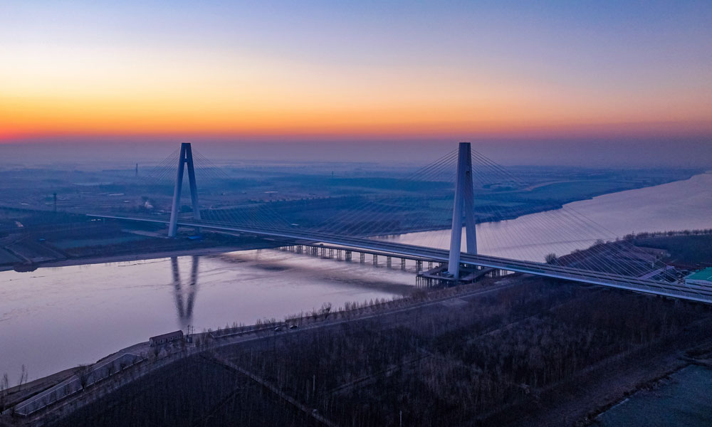 大橋地處黃河三角洲，海陸交互沉積區地質松軟易液化。為解決地質軟弱這一大難題，大橋主塔采用100根直徑2米，長度超百米的樁基插入松軟的地下，就像100根細長的筷子插在豆腐之上，為34000余噸的橋面提供承載和穩定性，也創造出了黃河之上最長群樁基礎。其中，樁基鉆孔最深處達到了130米，相當于43層樓高。