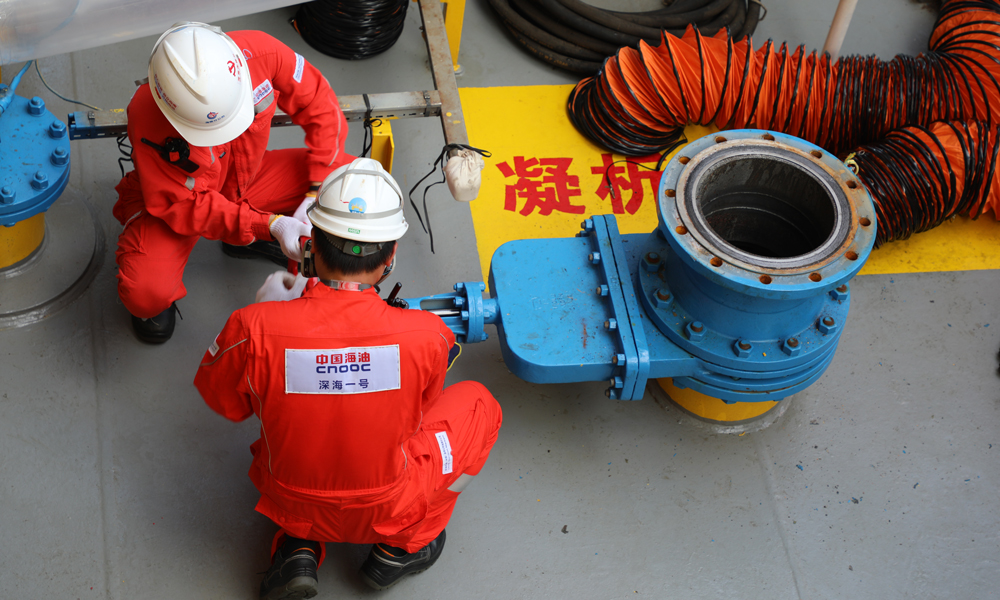 此前，“深海一號”能源站順利完成投產以來首次凝析油艙清艙檢測作業，檢測結果表明艙室運行狀態良好，能源站設計契合深海油氣開發實際需求，充分驗證了我國首創的深水半潛式儲卸油生產平臺設計的可靠性和先進性。圖為“深海一號”現場作業人員打開凝析油艙移動泵接入管線閘閥。周宇 攝